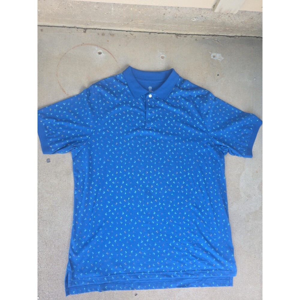 Harbor Bay polo shirt is a blue cotton blend featuring a colorful palm tree...